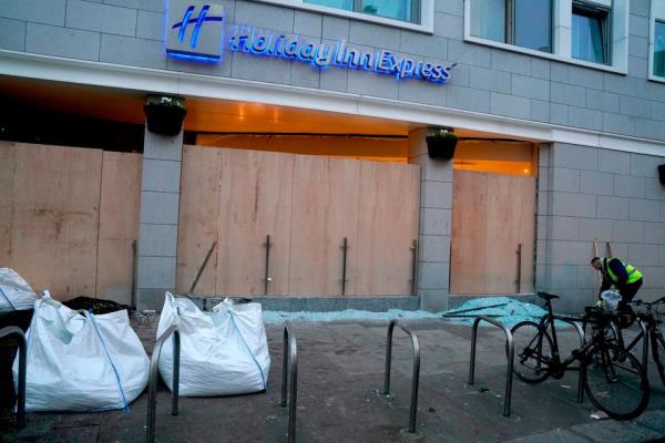 The debris from broken windows of the Holiday Inn Express. Photo: Brian Lawless/PA Wire
