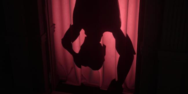 an upside-down silhouette of a mannequin on a red curtain in layers of fear 2023