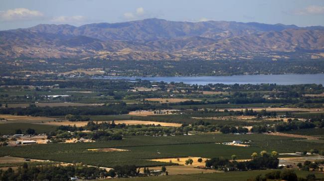 Looking out over Kelseyville and Finley with the west end of Clear Lake visible, shows a patch work of Pear orchards, vineyards and pasture land and Cow Mountain in the distance, Tuesday, Sept. 10, 2019. (Kent Porter / The Press Democrat file)