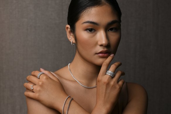 Model Kristena Seedwell wears a selection of Michael Hill’s new range of lab-grown diamond jewellery, including 1.8 carat tennis bracelet ($2,659) and 3.5 carat emerald-cut eternity ring ($7,999), at the company’s head office in Brisbane.