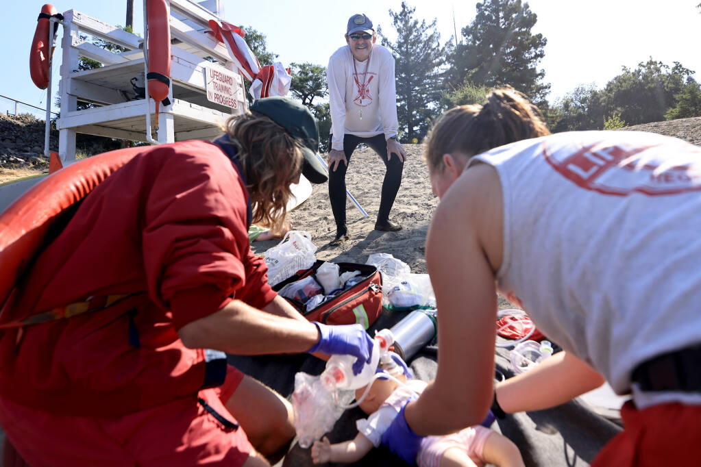 Supervising lifeguard Jim Boyce oversees CPR training with lifeguards James “Maverick” Cheney, 19, left, and Lauren Summers at Healdsburg Veterans Memorial Beach on the Russian River, Thursday, July 20, 2023. (Kent Porter / The Press Democrat)