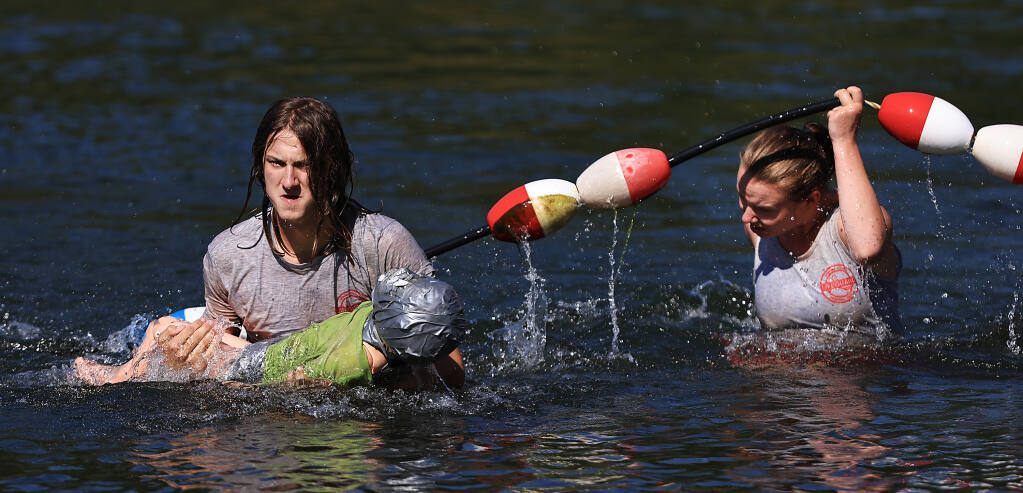 Lifeguards James 'Maverick' Cheney, 19, and Lauren Summers practice a rescue with “Bucket” the mannequin at Healdsburg Veterans Memorial Beach on the Russian River, Thursday, July 20, 2023. (Kent Porter / The Press Democrat)