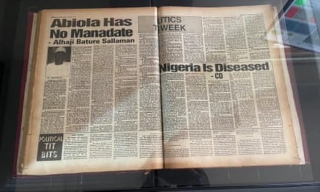 Boyega Adediran scans old newspapers as Grace Abraham uploads digital copies in the Lagos offices of Archivi.ng.
