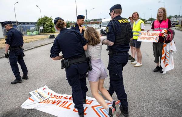 Police officers carry Swedish climate activist Greta Thunberg away from a protest June 19 that was blocking oil tankers in Malm?, Sweden.