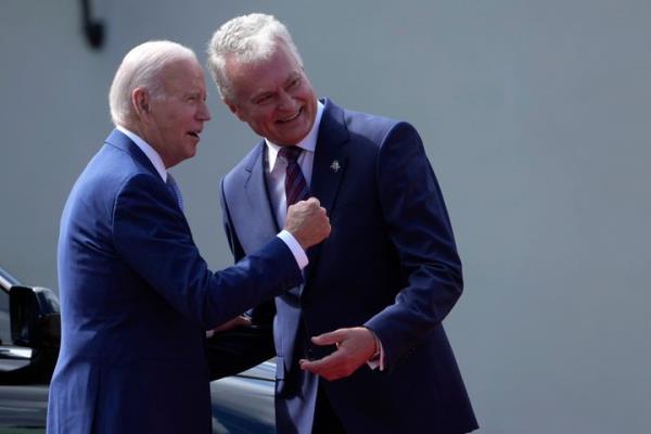 Lithuania's President Gitanas Nauseda, right, welcomes U.S. President Joe Biden at the Presidential Palace prior the NATO summit in Vilnius, Lithuania, on July 11, 2023.