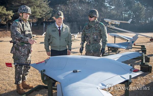 Defense Minister Shin Won-sik (C) checks a drone at the Drone Operations Command in Pocheon, 52 kilometers northeast of Seoul, on Jan. 8, 2024, in this photo provided by his office. (PHOTO NOT FOR SALE) (Yonhap)
