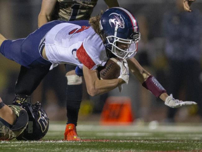 Rancho Cotate’s Tupotu Poueu Hale dives through the Windsor defense for a first down the third quarter in Windsor on Friday, Oct. 14, 2022. (Chad Surmick / The Press Democrat)