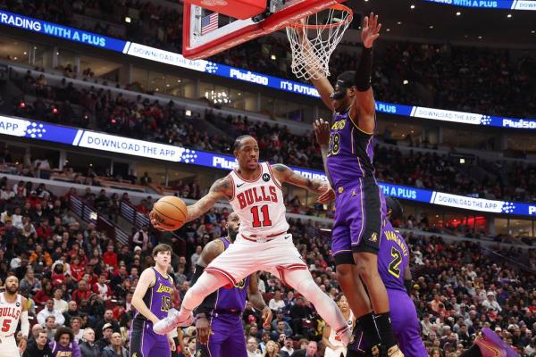 Bulls forward DeMar DeRozan looks to pass around Lakers forward Rui Hachimura in the first half Wednesday, Dec. 20, 2023, at the United Center.