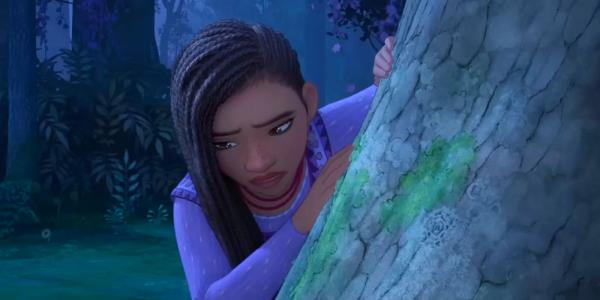 Ariana DeBose as Asha Leaning Sadly Against a Tree in Wish