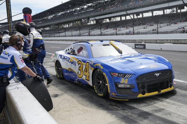 Michael McDowell makes a pit stop during a NASCAR Cup Series auto race at Indianapolis Motor Speedway, Sunday, Aug. 13, 2023, in Indianapolis. (AP Photo/Darron Cummings)