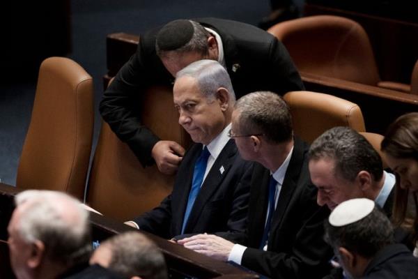 Israel's Prime Minister Benjamin Netanyahu, center, is surrounded by lawmakers at a session of the Knesset, Israel's parliament, in Jerusalem, Israel, Monday, July 24, 2023. (AP Photo/Maya Alleruzzo)