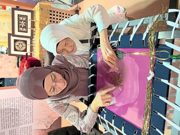 Nik Marhammah (left) and her grandaunt Nik Rahimah are Kelantan’s last remaining kelingkan embroiderers. Photo: Amirul Muhammad 