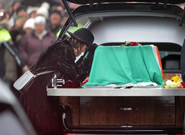 Victoria Mary Clarke takes a few moments at Shane MacGowan's coffin