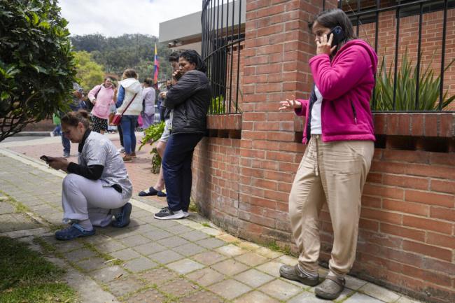 Residents gather outside their homes after a quake was felt in Bogota, Colombia, Thursday, Aug. 17, 2023. A magnitude 6.3 earthquake shook Colombia's capital and other major cities on Thursday, according to reports by United States Geological service. USGS reported a second 5.7 magnitude quake shortly after the first. (AP Photo/Ricardo Mazalan)