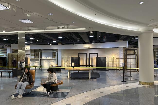 Two women sit outside an empty section of Nordstrom at the Westfield San Francisco Centre shopping mall on June 21, 2023. San Francisco's downtown has seen an exodus of retailers and now a shopping mall owner is turning the complex over to its lender in the face of declining foot traffic and empty office space. While San Francisco faces some of its own unique issues the problems serve as warning signs for other downtowns across the country, which are also feeling some pain. (AP Photo/Eric Risberg)