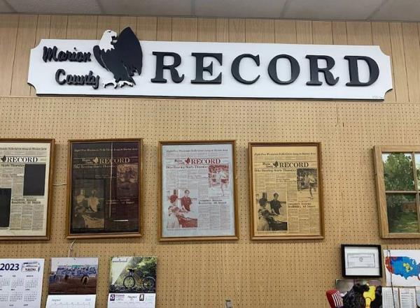 Front pages from previous editions hang on a wall at the Marion County Record, where police served a search warrant on Aug. 11, 2023, in Marion, Kansas.