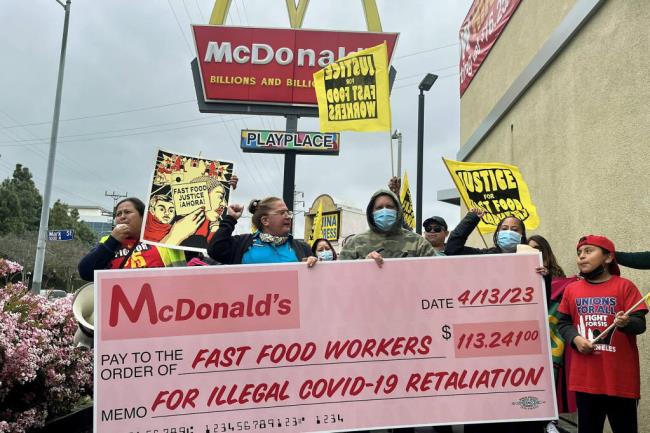 McDonald's workers, including Lizzet Aguilar, celebrate winning a state retaliation claim against a Boyle Heights franchise location. Four workers won more than $100,000 in lost hours, penalties and backpay after they alleged the owners illegally retaliated against them for making a workplace safety complaint during the pandemic. Photo by Alejandra Reyes-Velarde, CalMatters