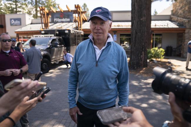 President Joe Biden talks with reporters after taking a Pilates and spin class at PeloDog, Friday, Aug. 25, 2023, in South Lake Tahoe, Calif. (AP Photo/Evan Vucci)