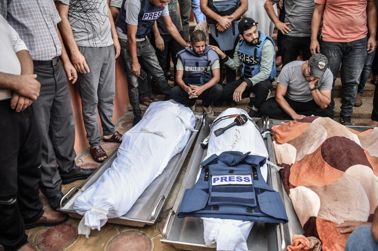 Palestinian journalists in blue 'Press' bulletproof vests mourn a colleague killed by Israeli forces, the Gaza Strip, Palestine. (AA Photo)