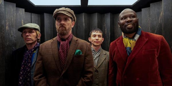 Brendan Hunt as Coach Beard standing in an elevator with other men in Ted Lasso
