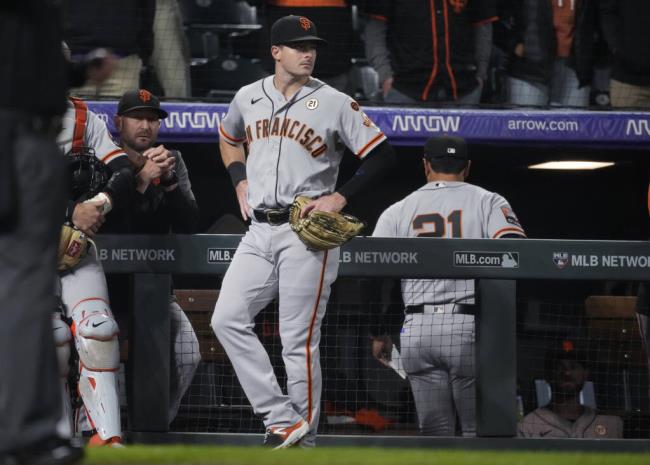 San Francisco Giants left fielder Mike Yastrzemski stands outside the dugout while the final play was being reviewed during the team’s game against the Colorado Rockies on Friday, Sept. 15, 2023, in Denver. A throwing error by Yastrzemski allowed the winning run to score. (David Zalubowski / ASSOCIATED PRESS)