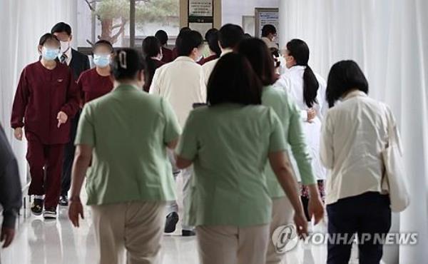 Medical workers walk in a hallway at a general hospital in Seoul on March 7, 2024. (Yonhap)