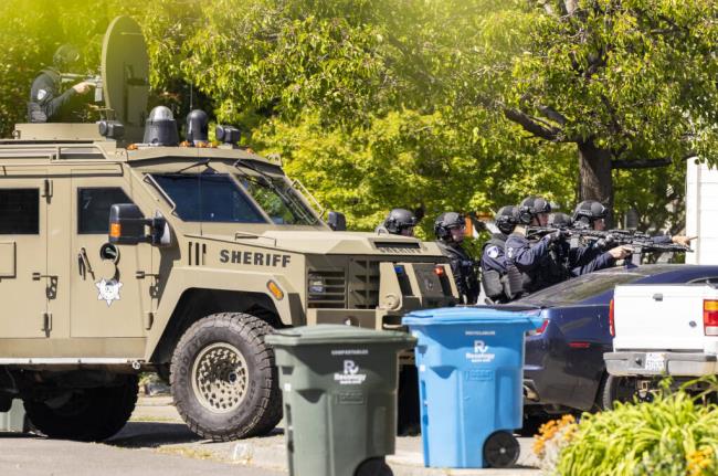 The Santa Rosa police department SWAT team moves in to enter a Humboldt. Street home on Wednesday, May 4, 2022, in search of a suspect, who was not home at the time. The man, Brad Adams, was sentenced to 11 years to life in prison.  (John Burgess / The Press Democrat file)